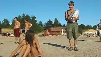 A Stunning Young Girl Disrobes And Enjoys Herself On The Beach